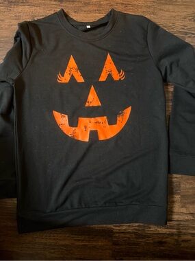 Black Sweatshirt with Orange Jack-O'-Lantern Graphic